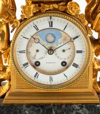 A Continental Gilt Bronze and Marble Figural Mantel Clock