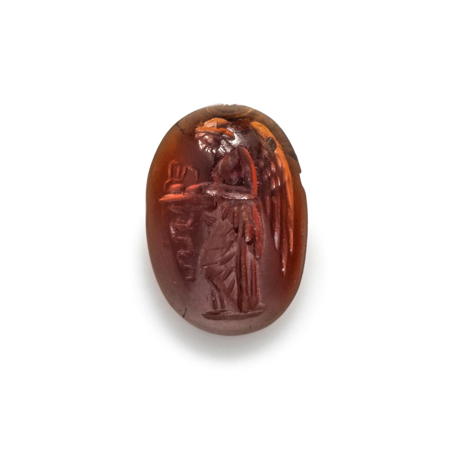 A Roman Garnet Ring Stone with the Goddess Nike at an Altar