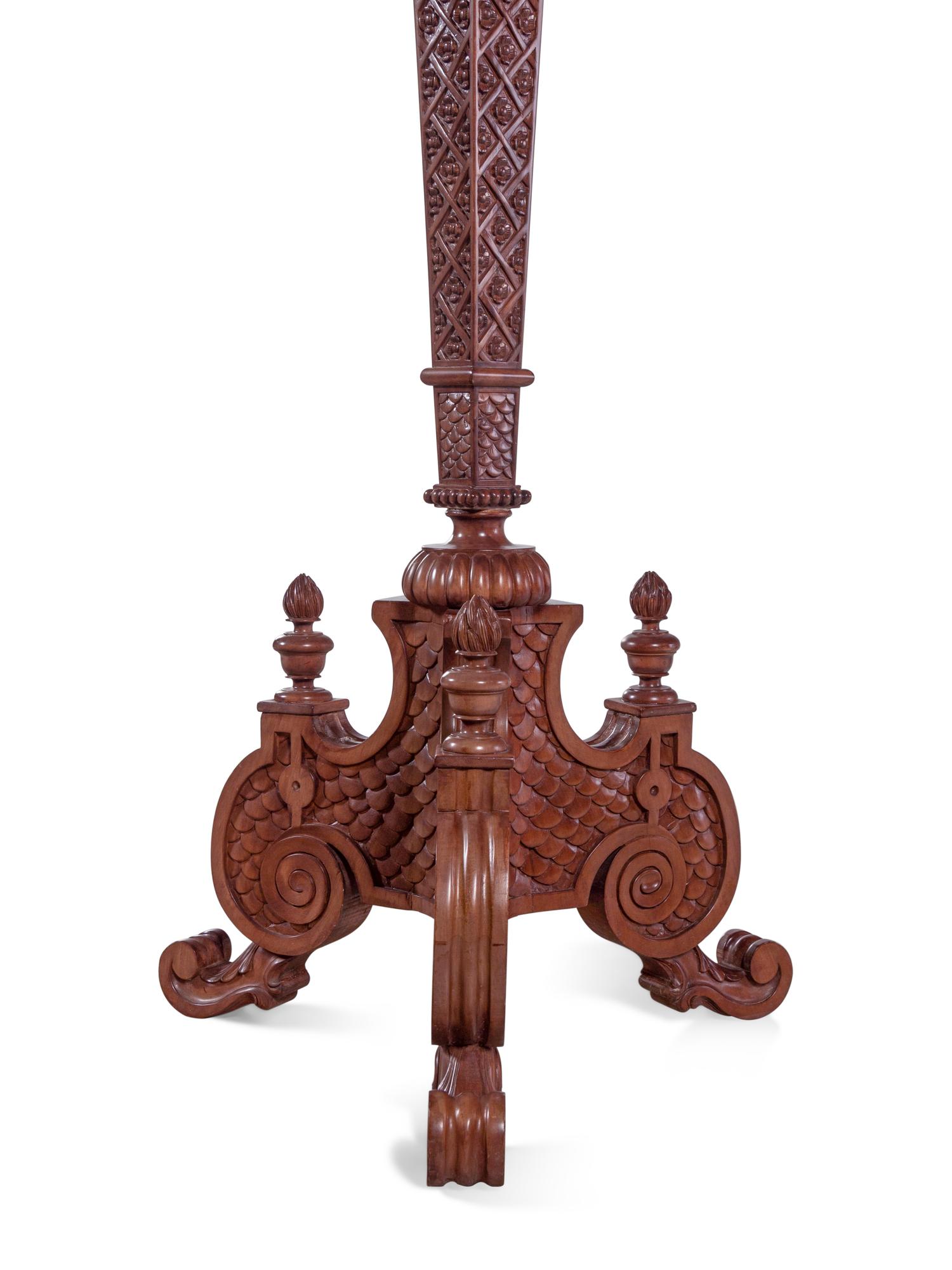 A Pair of Continental Carved Walnut Torchères