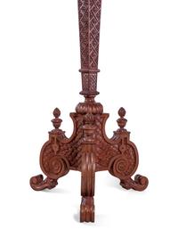 A Pair of Continental Carved Walnut Torchères