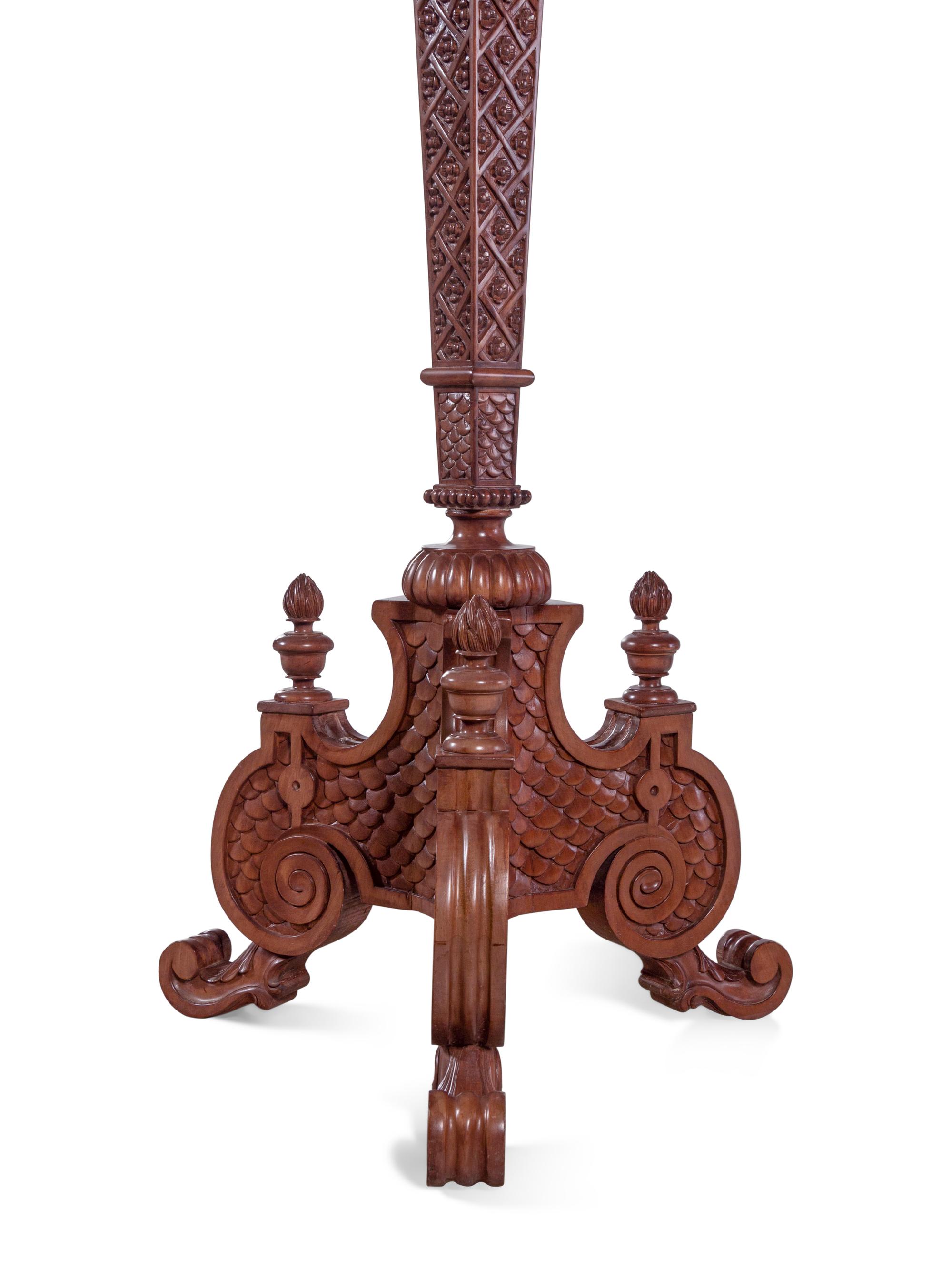 A Pair of Continental Carved Walnut Torchères