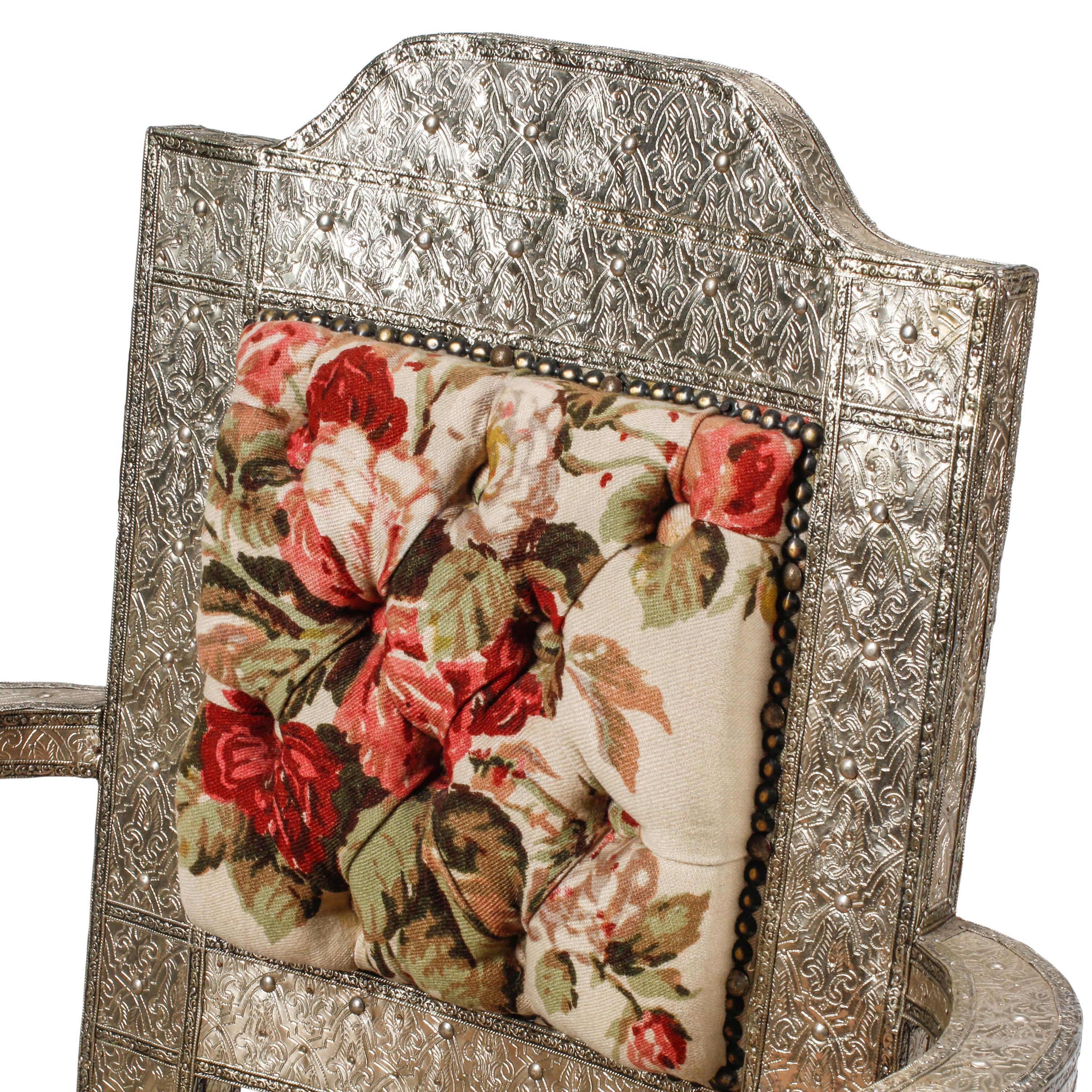 A Pair of Anglo-Colonial Silvered Metal-Clad Swiveling Armchairs