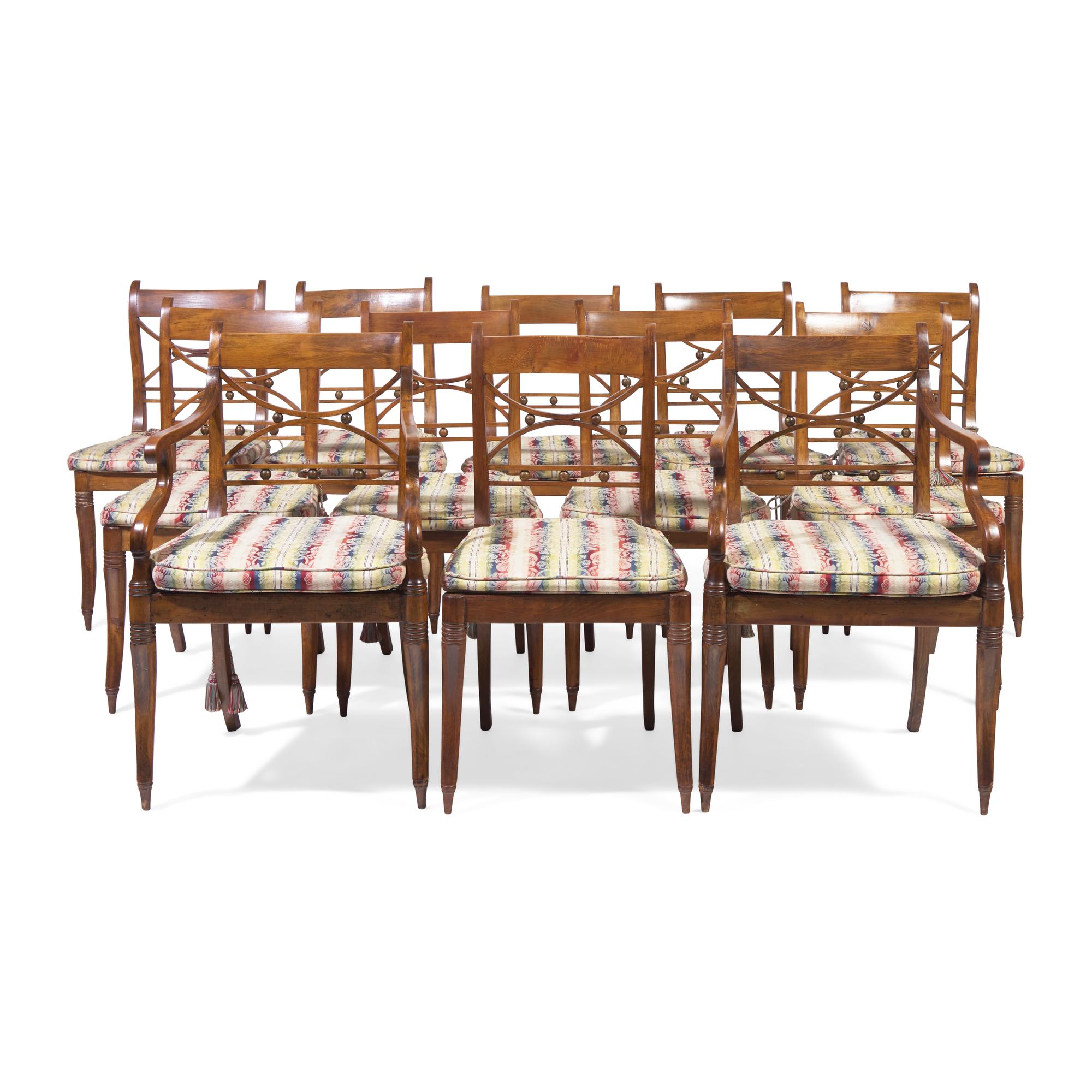 A Set of Twelve Regency Style Fruitwood Dining Chairs