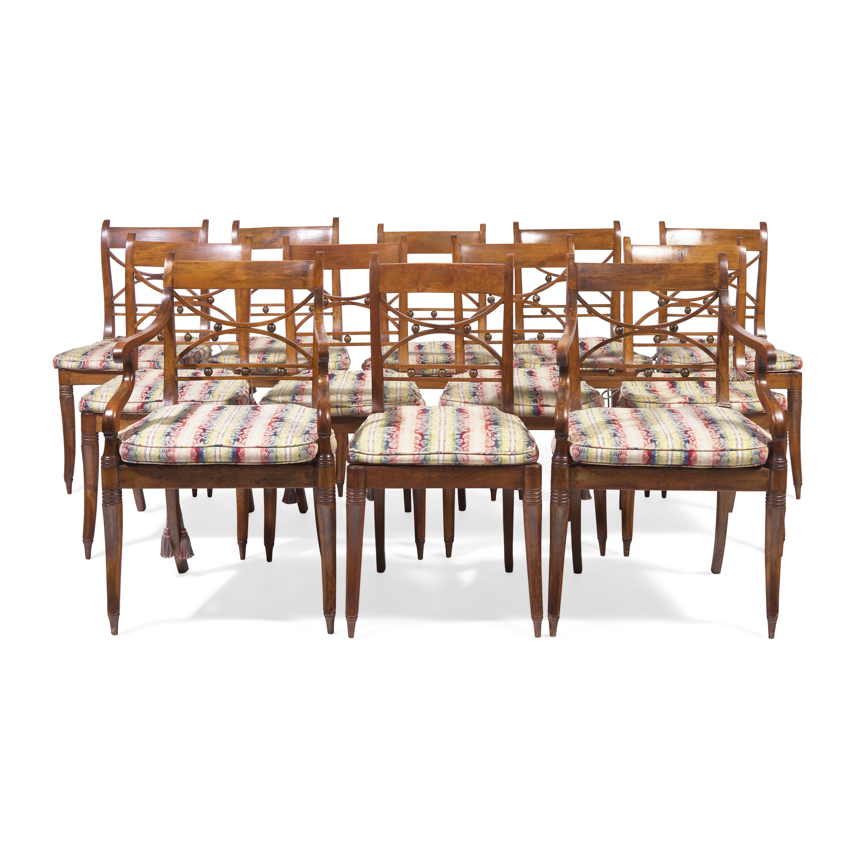 A Set of Twelve Regency Style Fruitwood Dining Chairs
