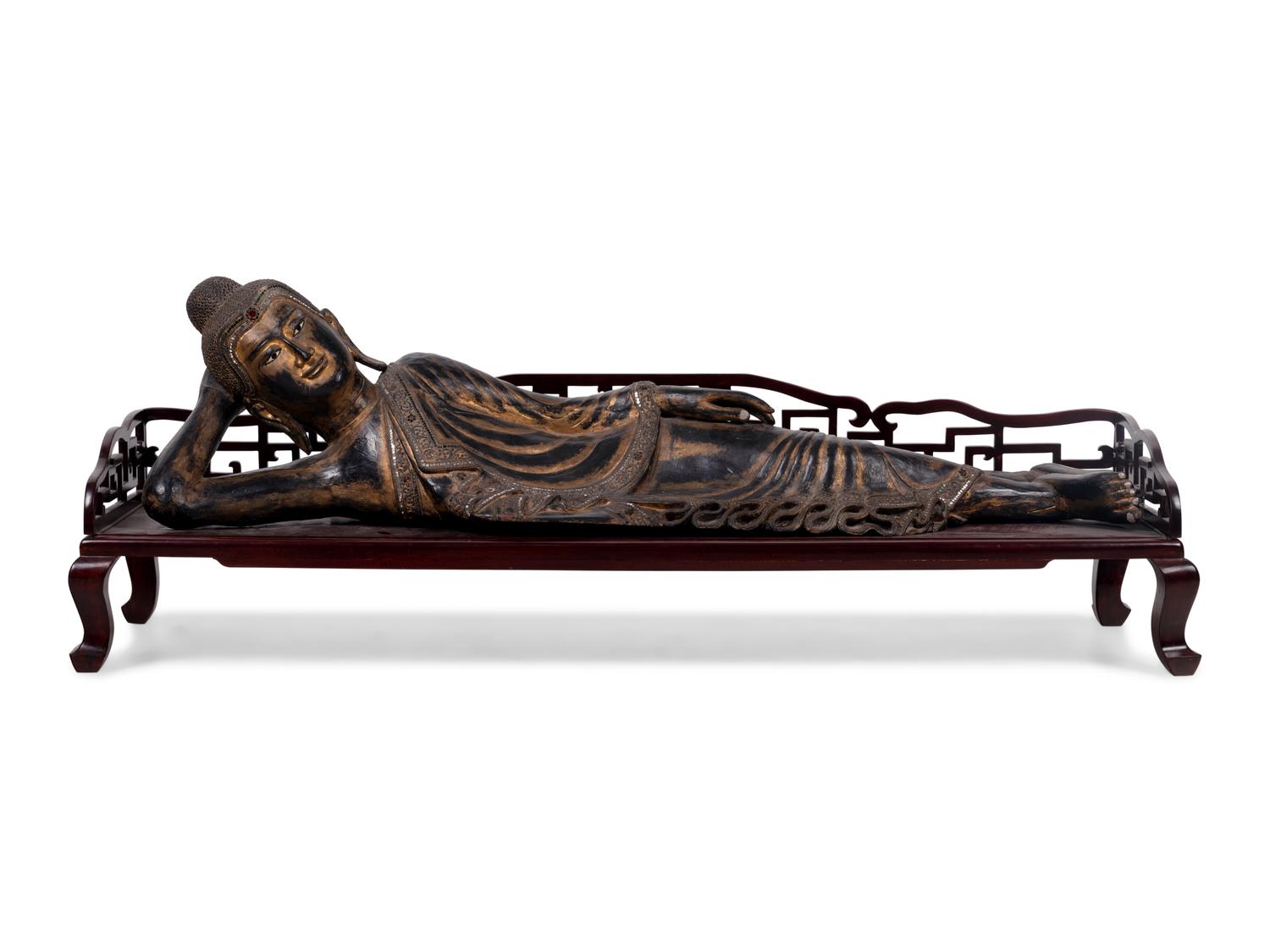 A Thai Gilt Decorated Black Lacquered Wood Figure of Reclining Buddha