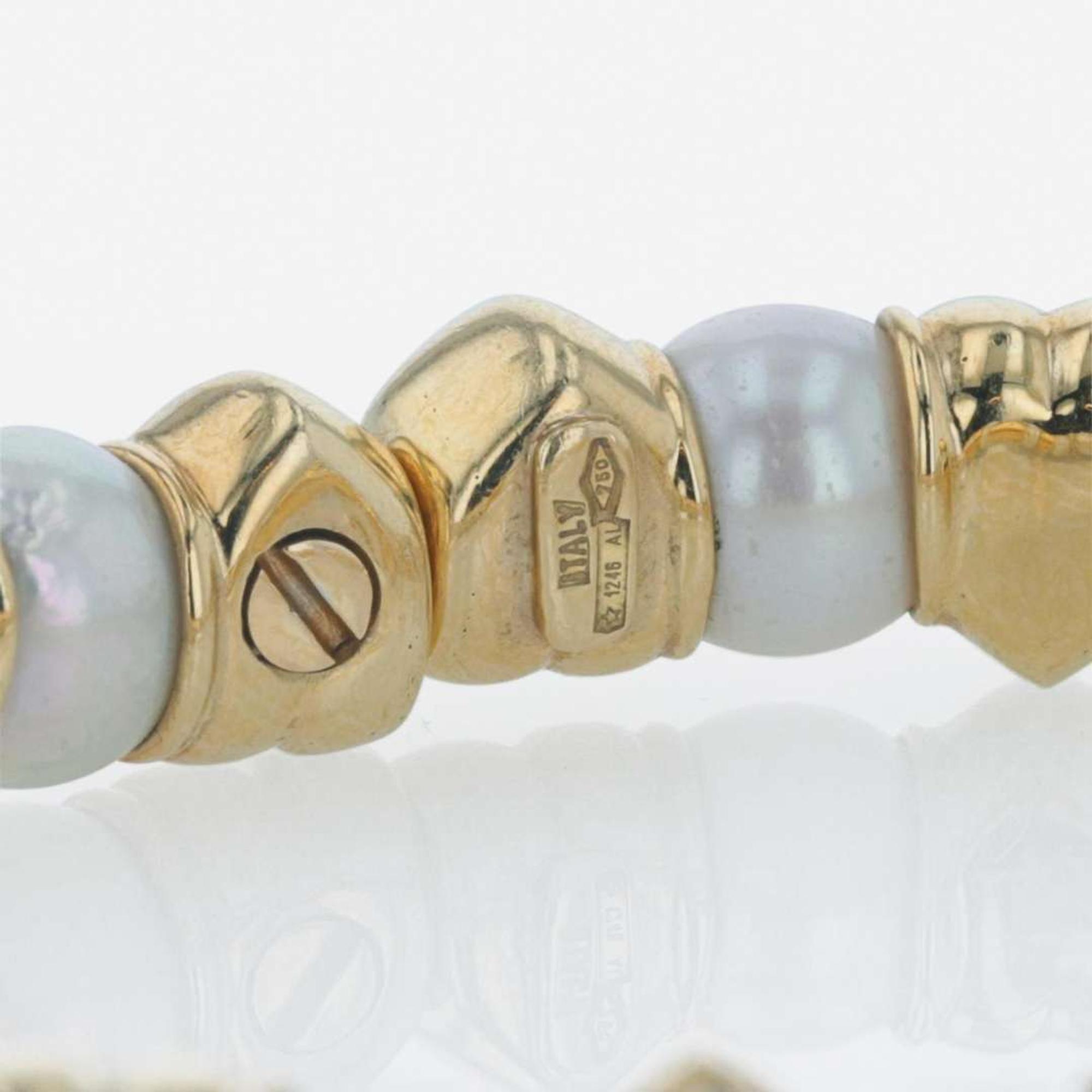 An 18K yellow gold, cultured pearl, and diamond bangle Italy