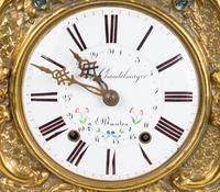 A French Repousséd Brass Comtoise Clock — 19TH CENTURY