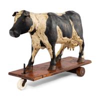 An Early Carved Cow Pulltoy