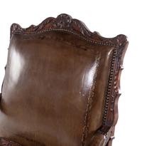 A Régence Style Carved Walnut Fauteuil with Leather Upholstery