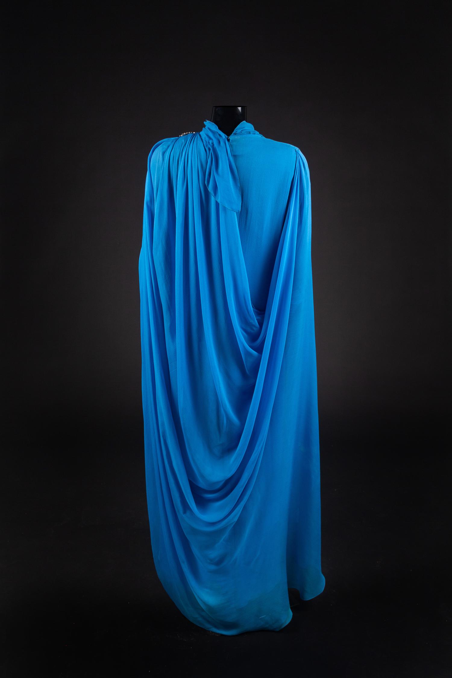Dress and Shoes, 1982. Dress design by Paul Zastupnevitch, made by Western Costume Company in Los Angeles. — Worn by Olivia de Havilland for ‘The Night of a Hundred Stars II” at the Radio City Hall in New York in 1985. Also worn for the White House State Dinner given by Ronald Reagan in honor of President Francois Mitterand on March 22, 1984.
