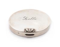 An American Silver Compact, Georg Jensen Inc., New York, NY, Circa 1940, or oval form, the lid with an engraved name and applied foliat
