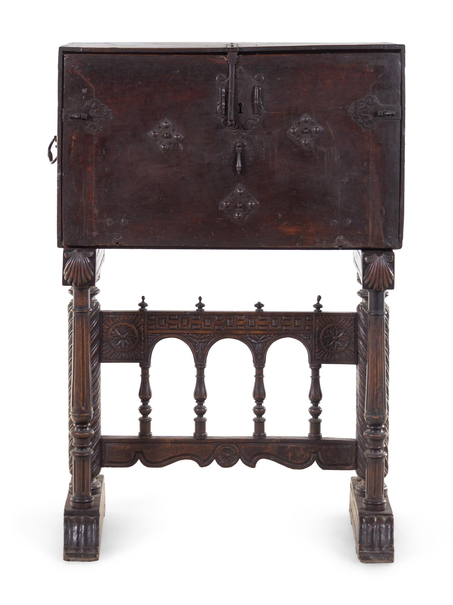 A Spanish Iron Mounted Carved Walnut Vargueño on Stand