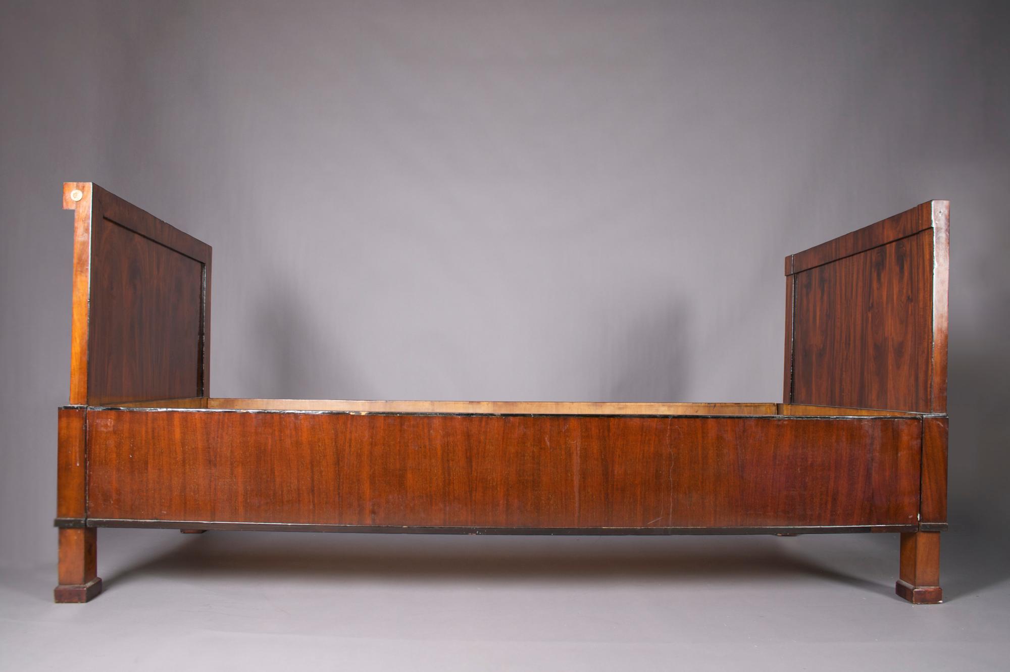 An Empire Mahogany Bed, Height 37 3/4 x width 81 inches.