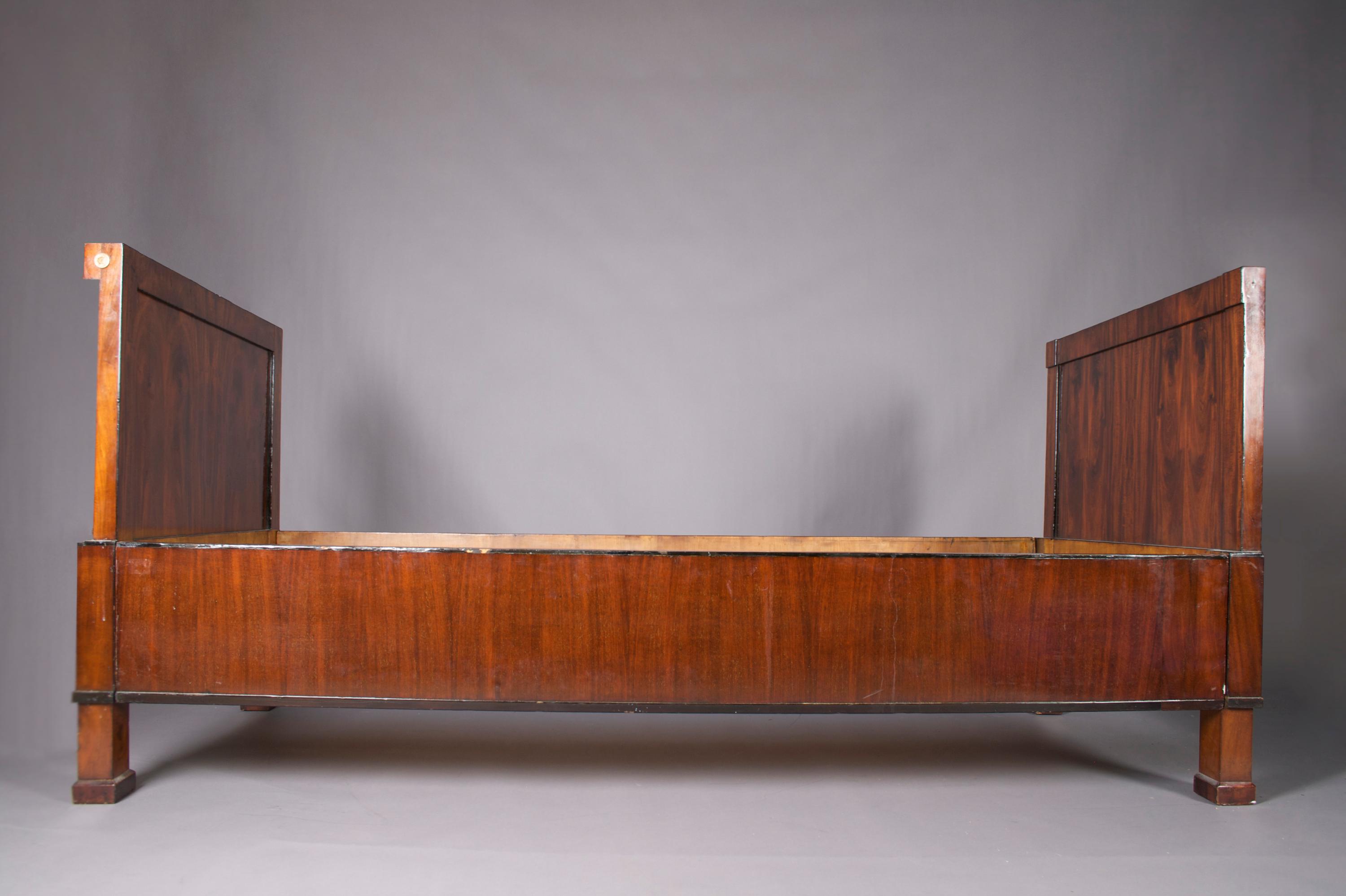 An Empire Mahogany Bed, Height 37 3/4 x width 81 inches.