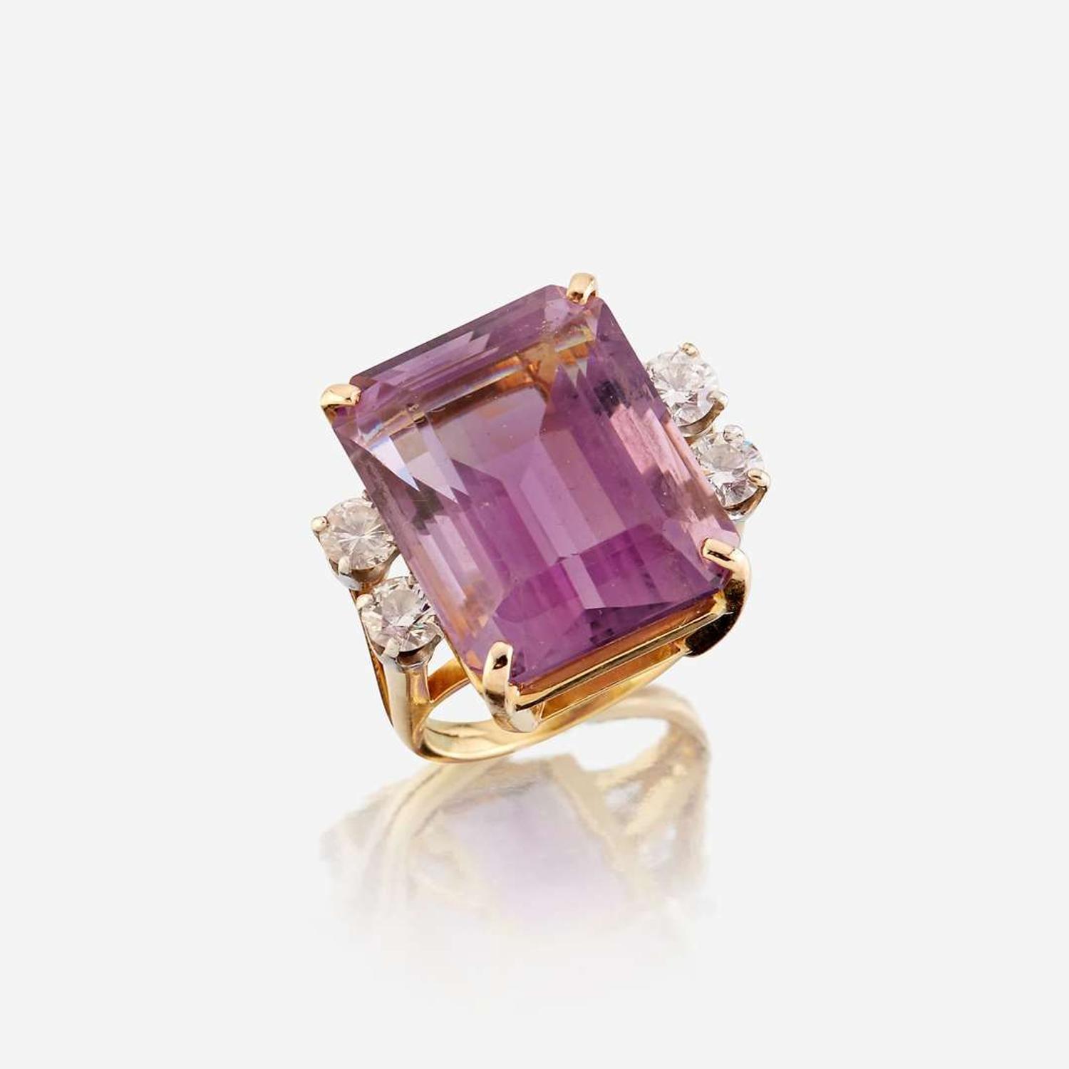 An amethyst, diamond, white stone, and gold ring