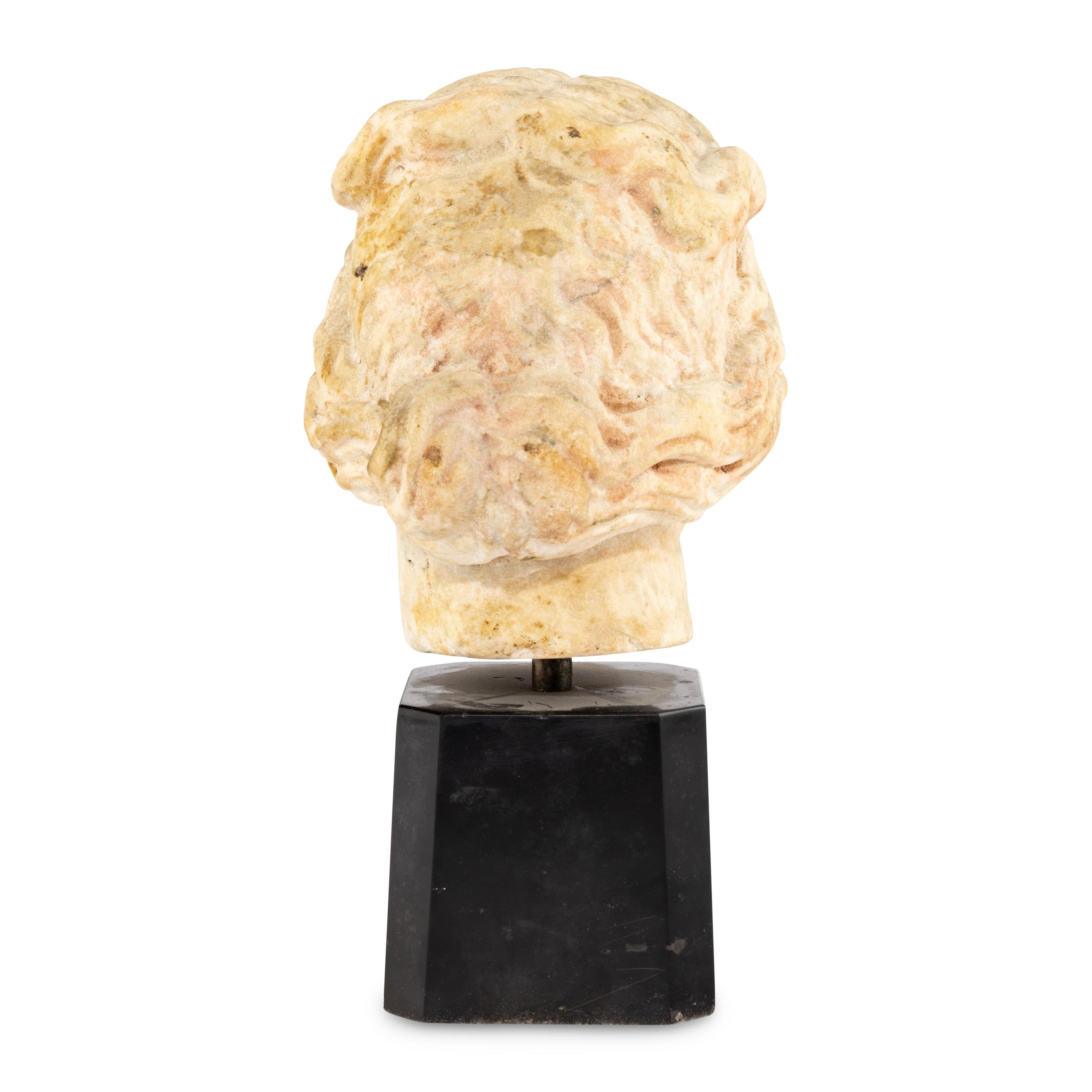 A Continental Carved Marble Head of a Woman