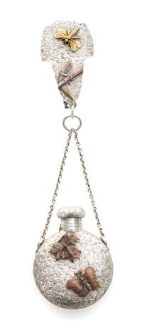 An American Silver and Mixed Metal Perfume Bottle, Dominick & Haff, New York, NY,, the bottle suspended from a chain to a central clip,