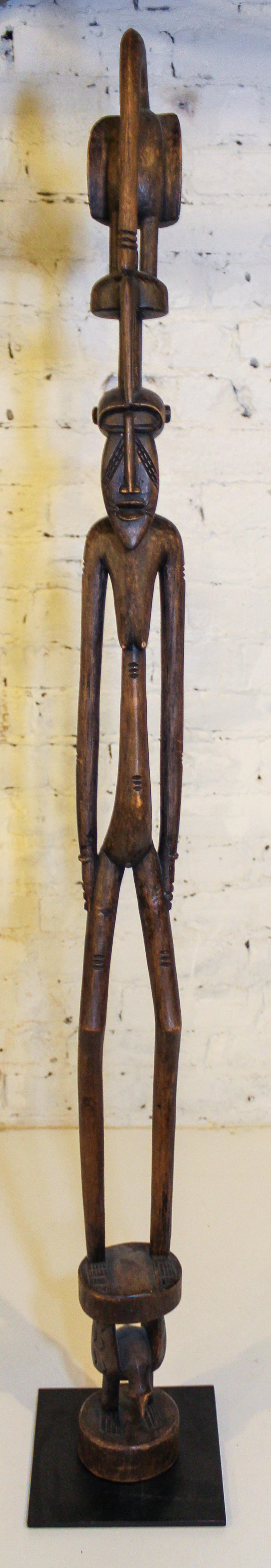 A Senufo Style Female Figure Height overall 55 inches.