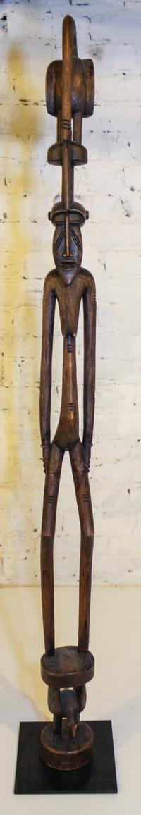 A Senufo Style Female Figure Height overall 55 inches.