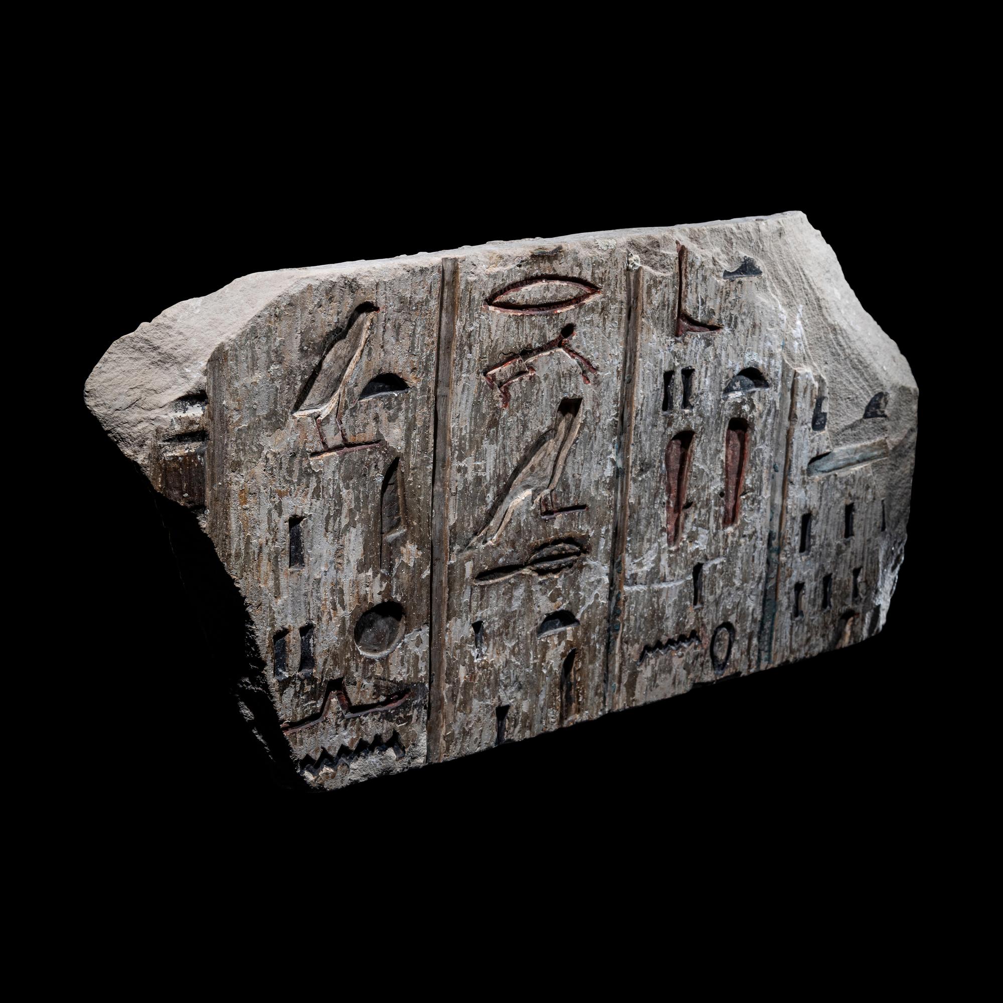 An Egyptian Polychrome Limestone Relief Fragment