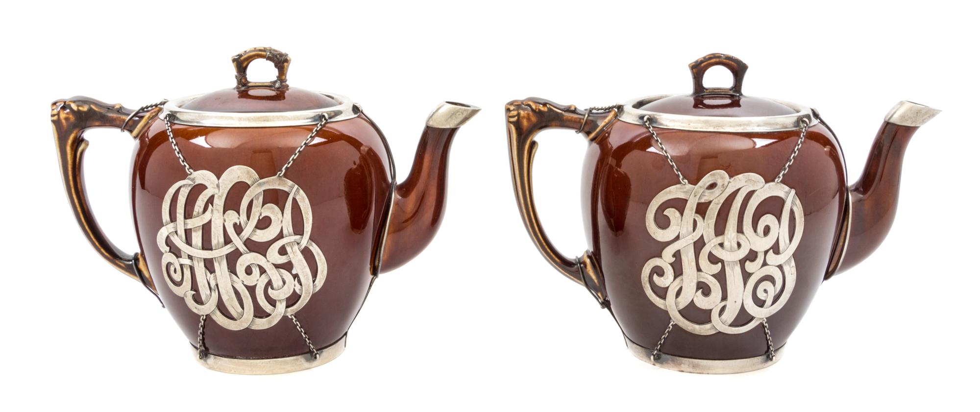 A Pair of Ceramic Silver Overlay Teapots Height of taller 6 inches.