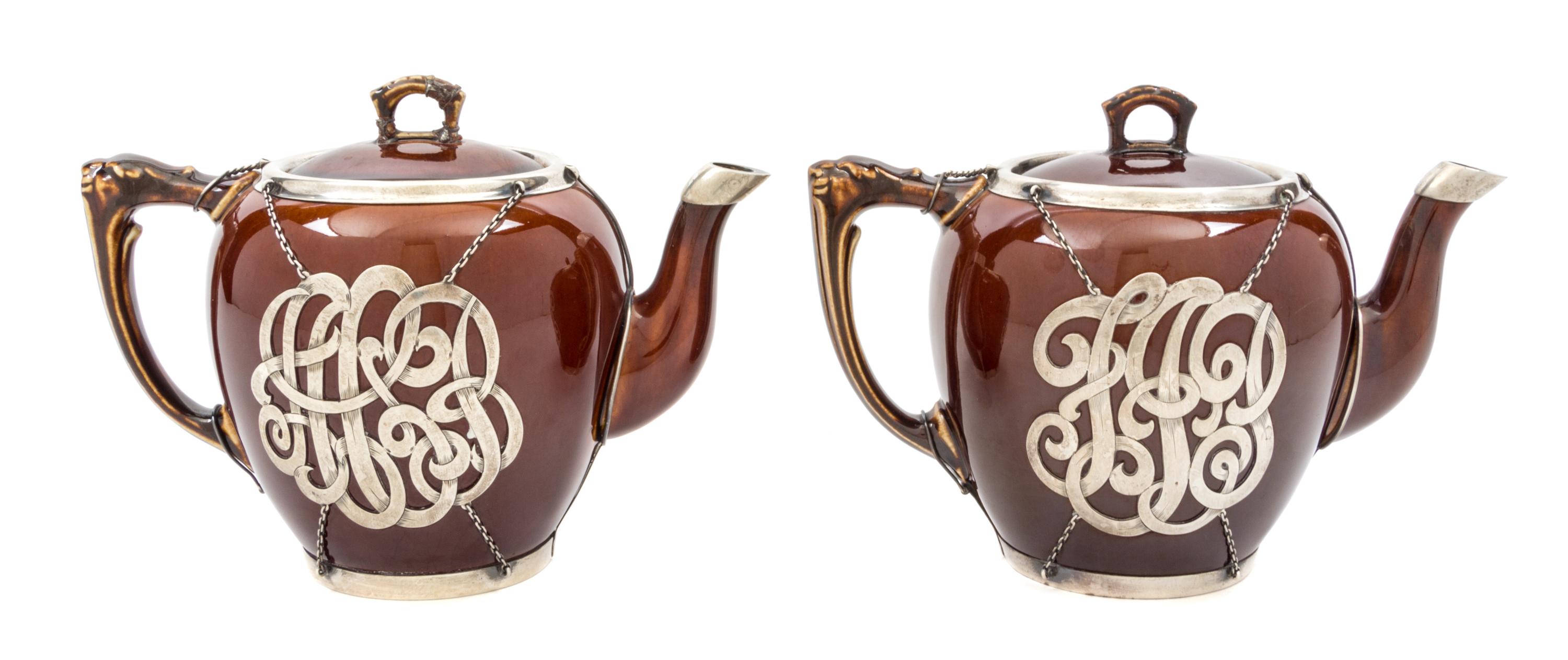 A Pair of Ceramic Silver Overlay Teapots Height of taller 6 inches.