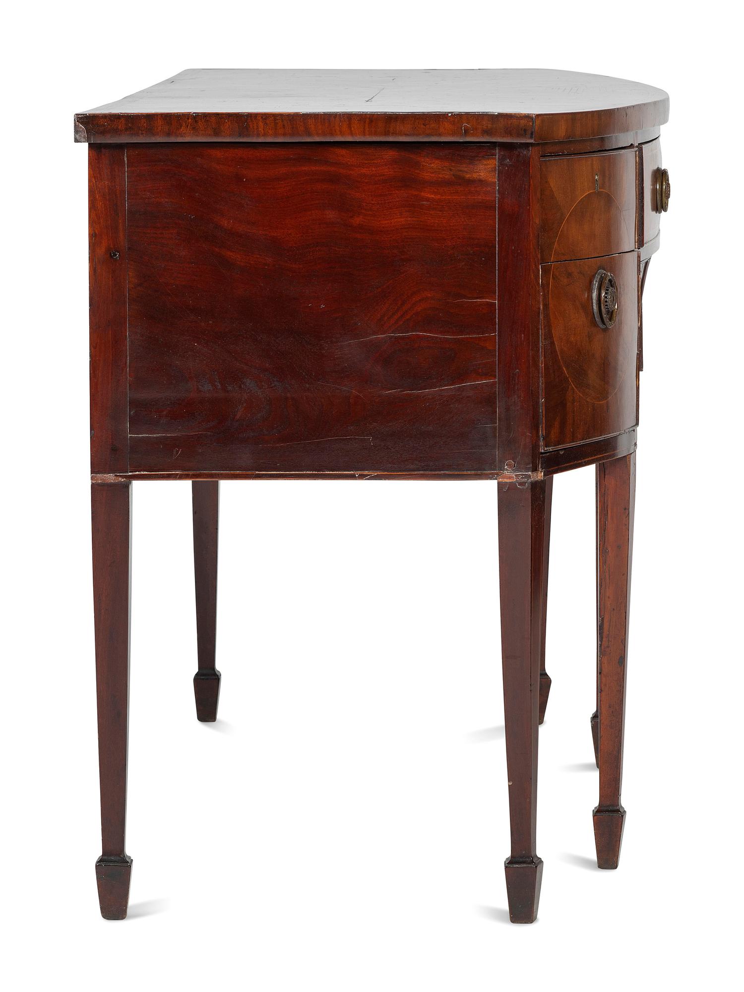 A Regency Carved, Inlaid and Figured Mahogany Bowfront Sideboard
