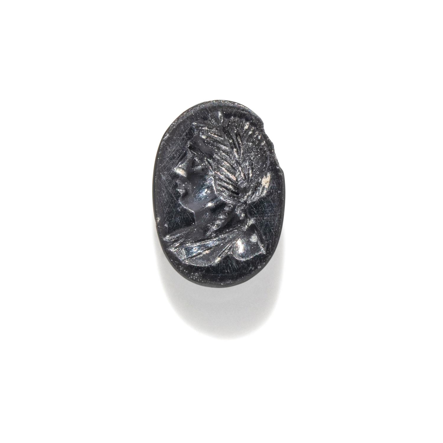 A Roman Hematite Ring Stone with a Male Portrait Head, Possibly the God Apollo