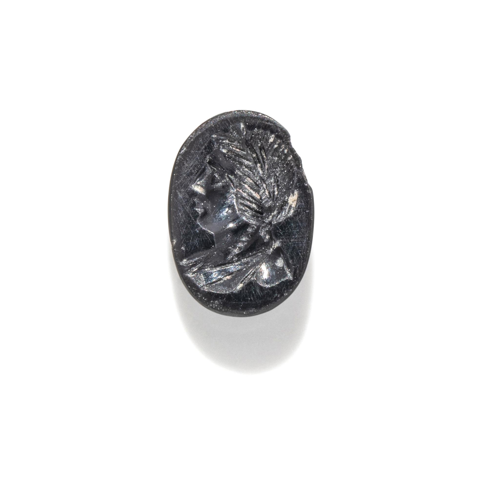 A Roman Hematite Ring Stone with a Male Portrait Head, Possibly the God Apollo