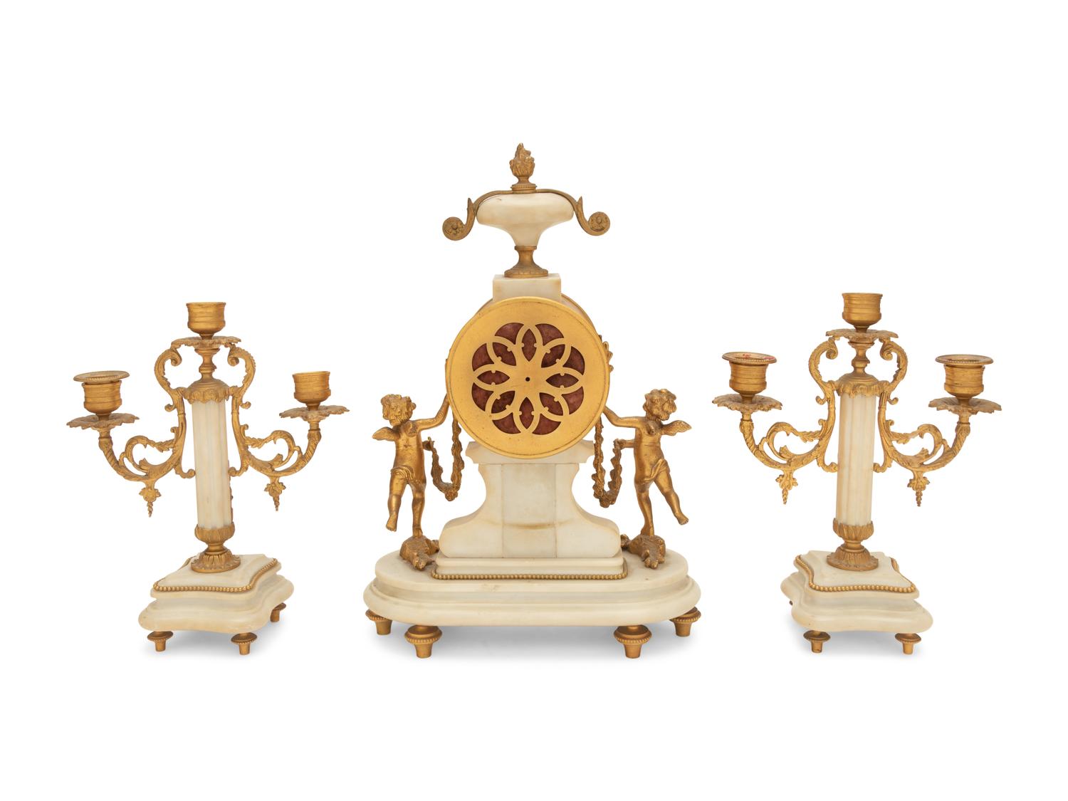 A Louis XVI Style Gilt Bronze and Marble Clock Garniture
