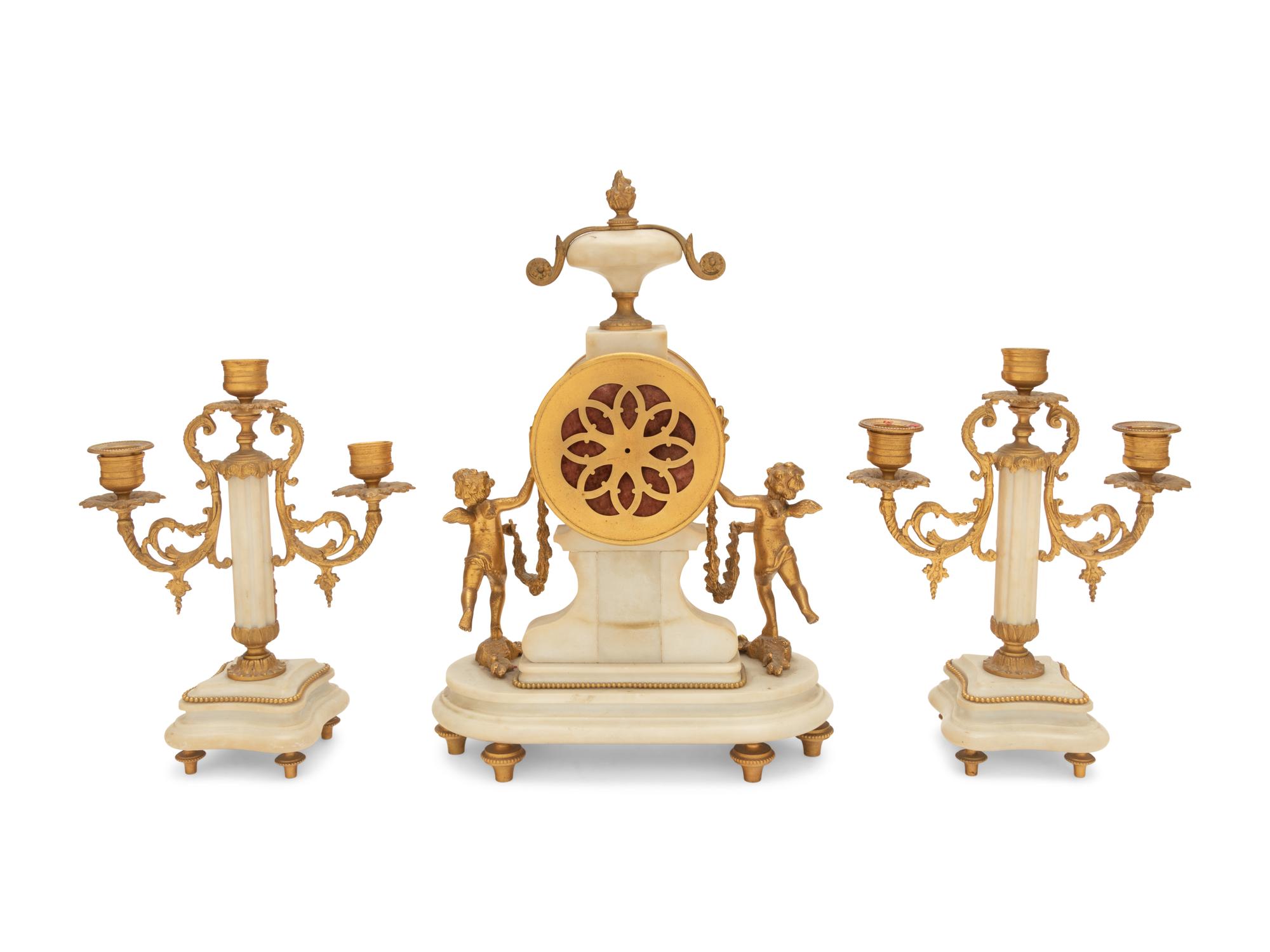 A Louis XVI Style Gilt Bronze and Marble Clock Garniture
