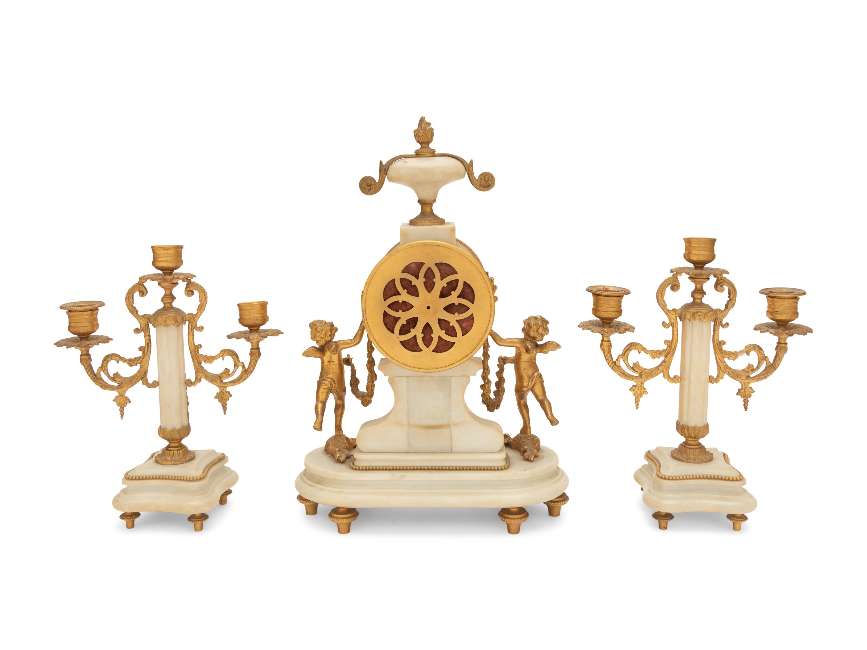 A Louis XVI Style Gilt Bronze and Marble Clock Garniture