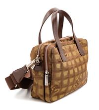 A Chanel Brown Nylon Travel Line Handbag, 8" H x 10" W x 4" D; Handle drop: 4.5".