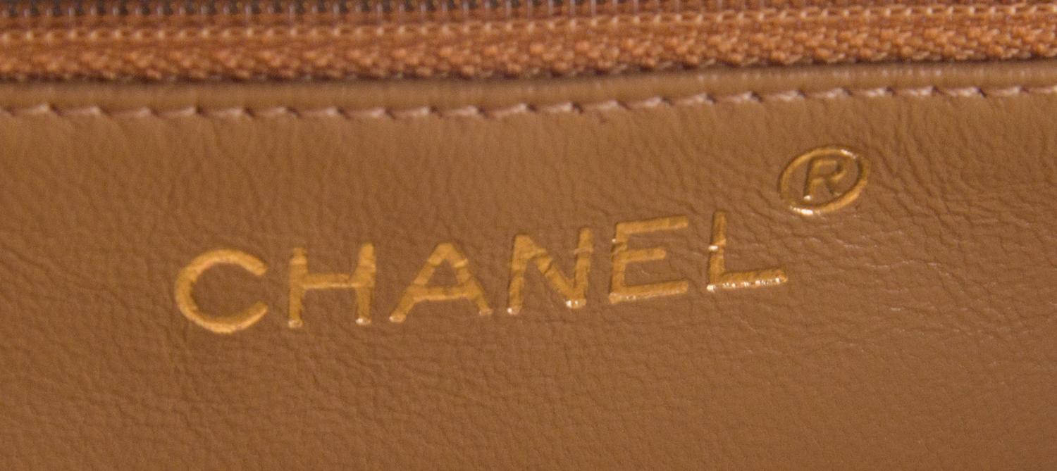 A Chanel Taupe Leather Handbag, 6" x 8" x 2.75".