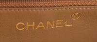 A Chanel Taupe Leather Handbag, 6" x 8" x 2.75".