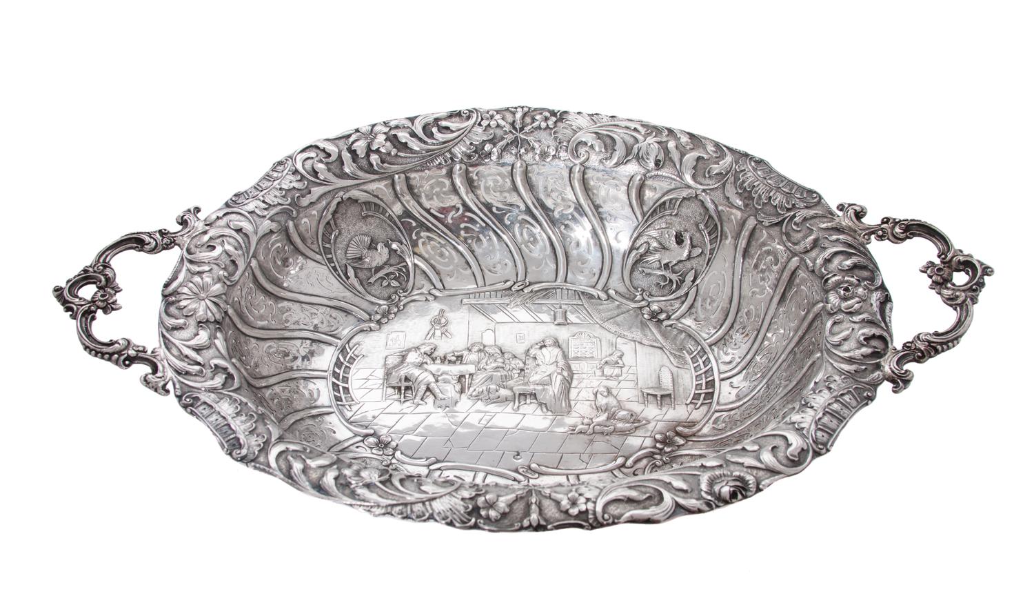 A Dutch Silver Repousse Serving Bowl, , of oval, two-handled form, with pierced sides and foliate rim centering a narrative.