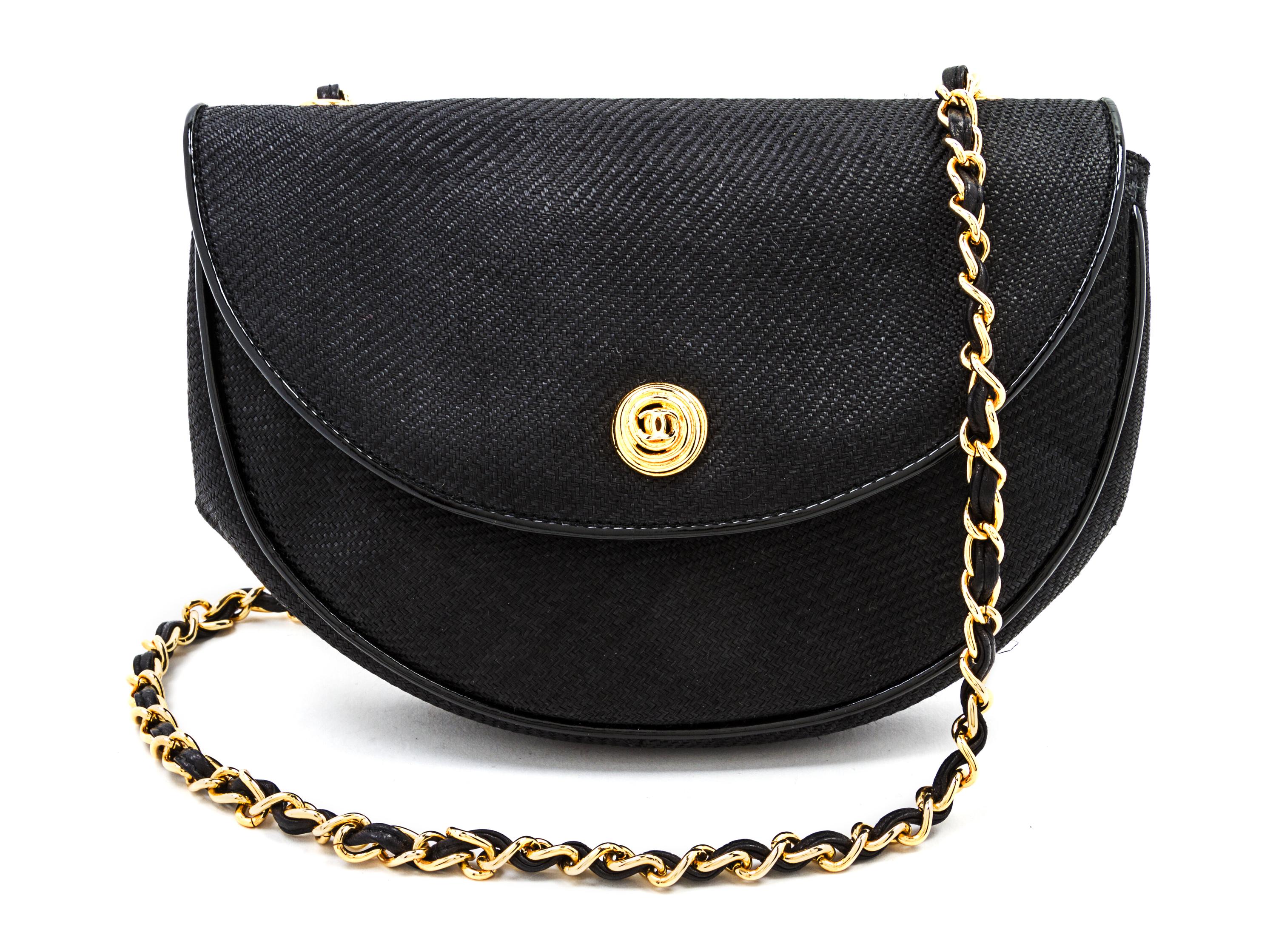 A Chanel Black Woven Straw Flap Bag, 8 x 6 x 2 inches.