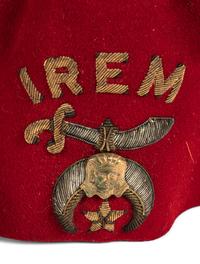 A Collection of Twenty-One Military Parade Helmets, Hats and Masks
