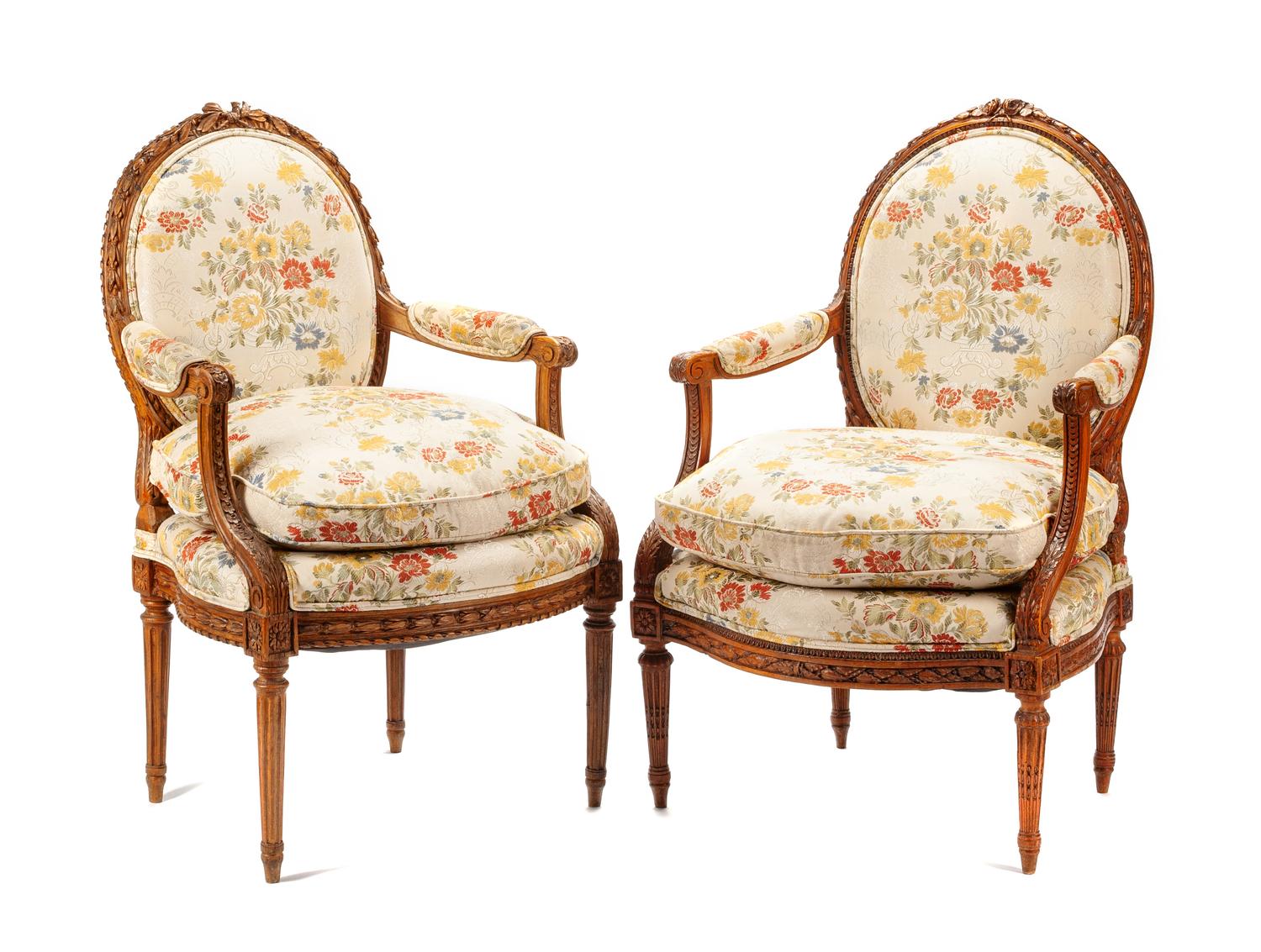 A Near Pair of Louis XVI Carved Walnut Fauteuils