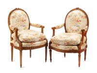 A Near Pair of Louis XVI Carved Walnut Fauteuils