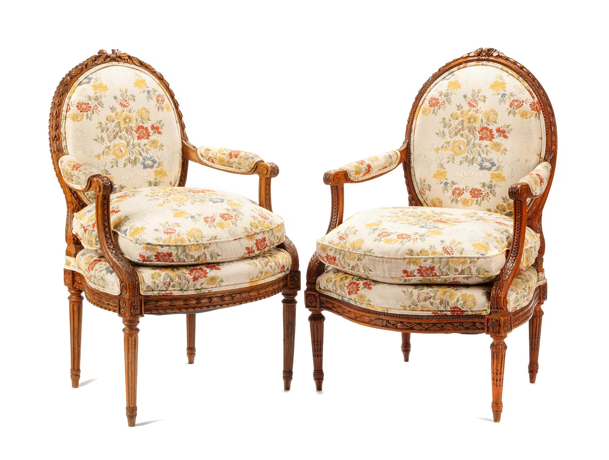 A Near Pair of Louis XVI Carved Walnut Fauteuils