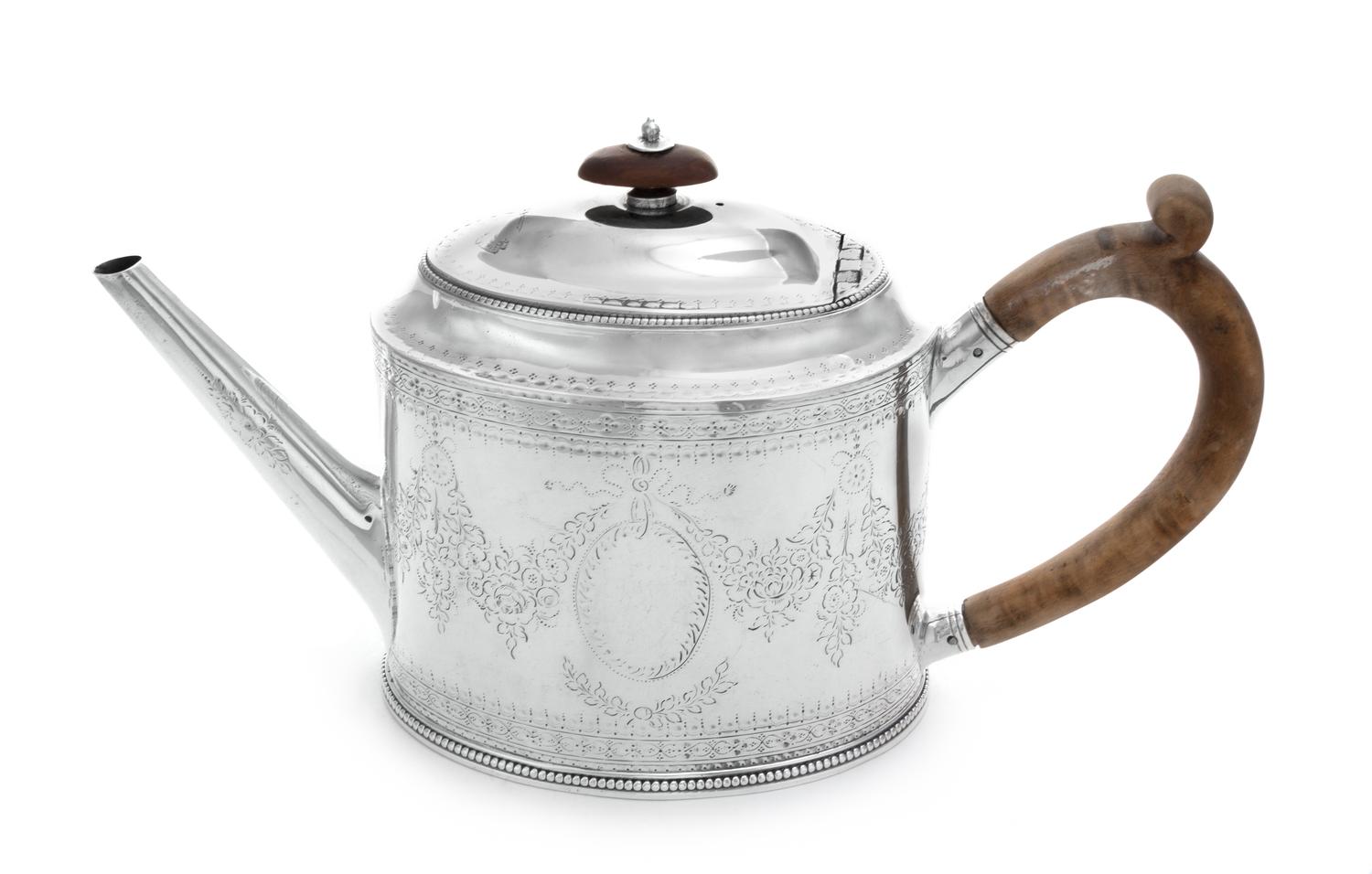 A George III Silver Teapot, Hester Bateman, London, 1783, of oval form, having a tapering spout and a scrolled wood handle, worked to s
