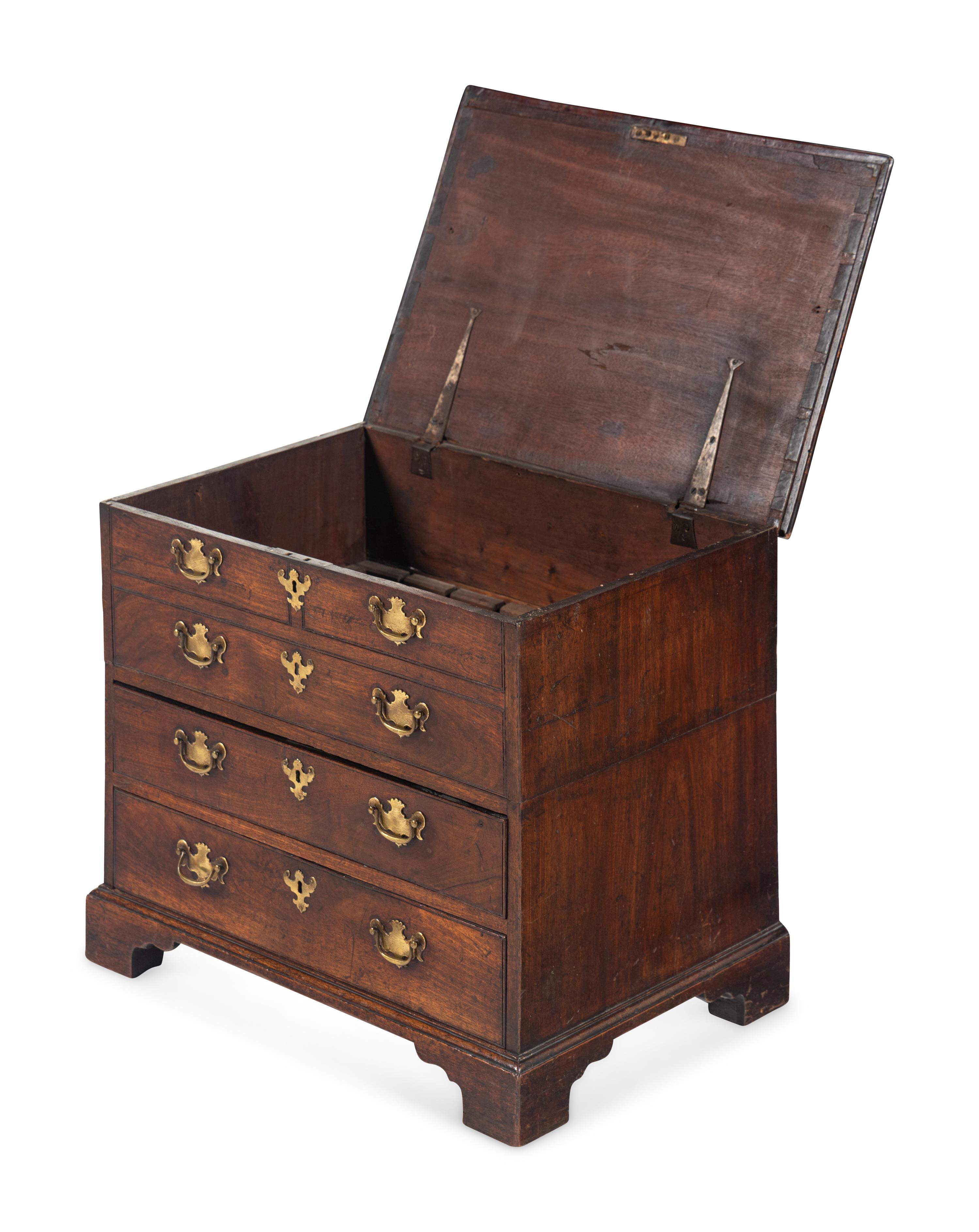 A George III Diminutive Lift-Top Chest of Drawers