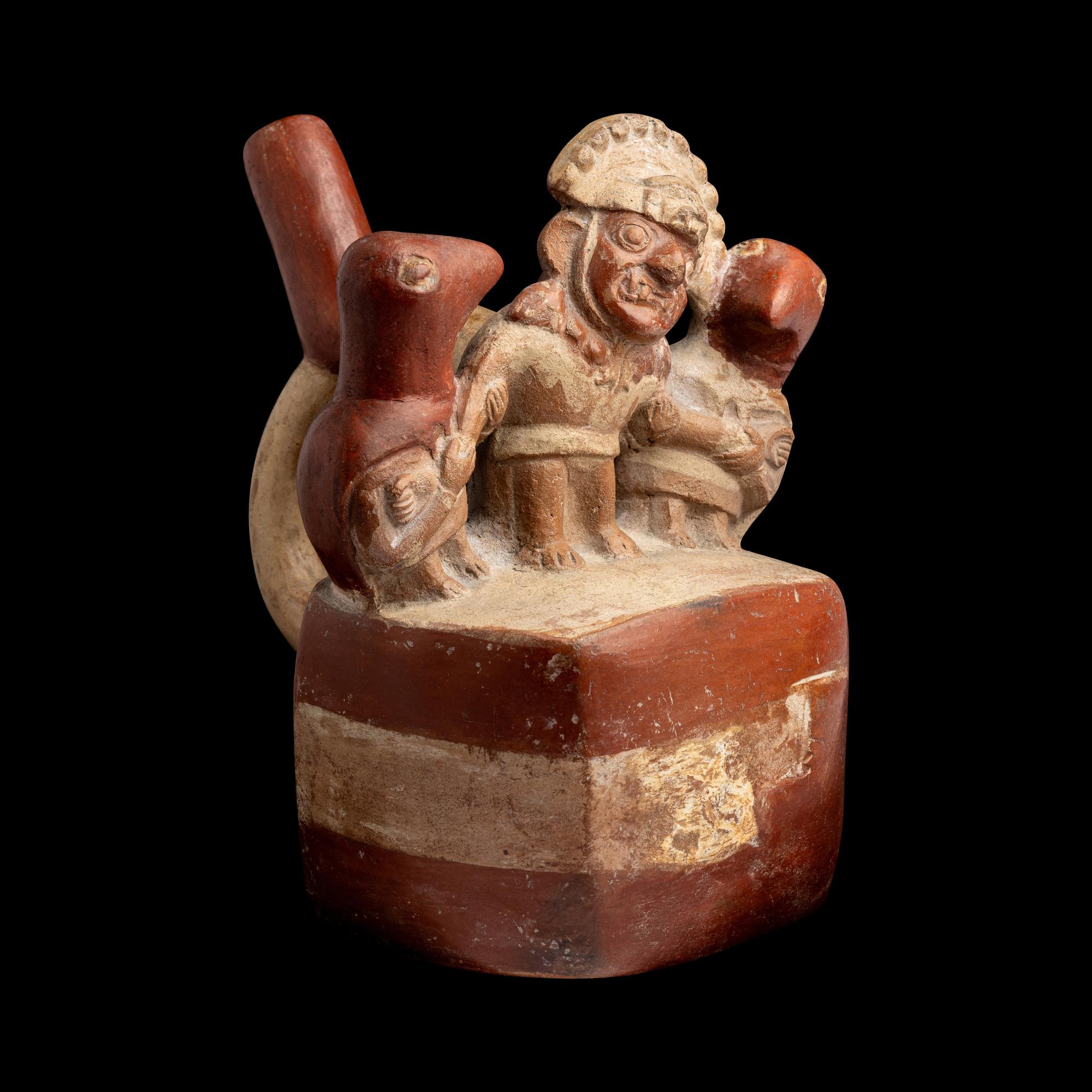 A Moche Stirrup Vessel in the Form of a Shaman with Two Anthropomorphic Figures