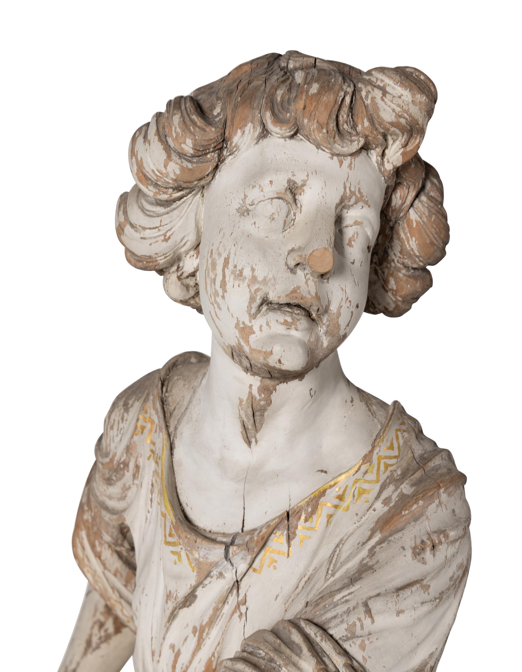 A Set of Three Carved, Painted and Parcel Gilt Wood Figures