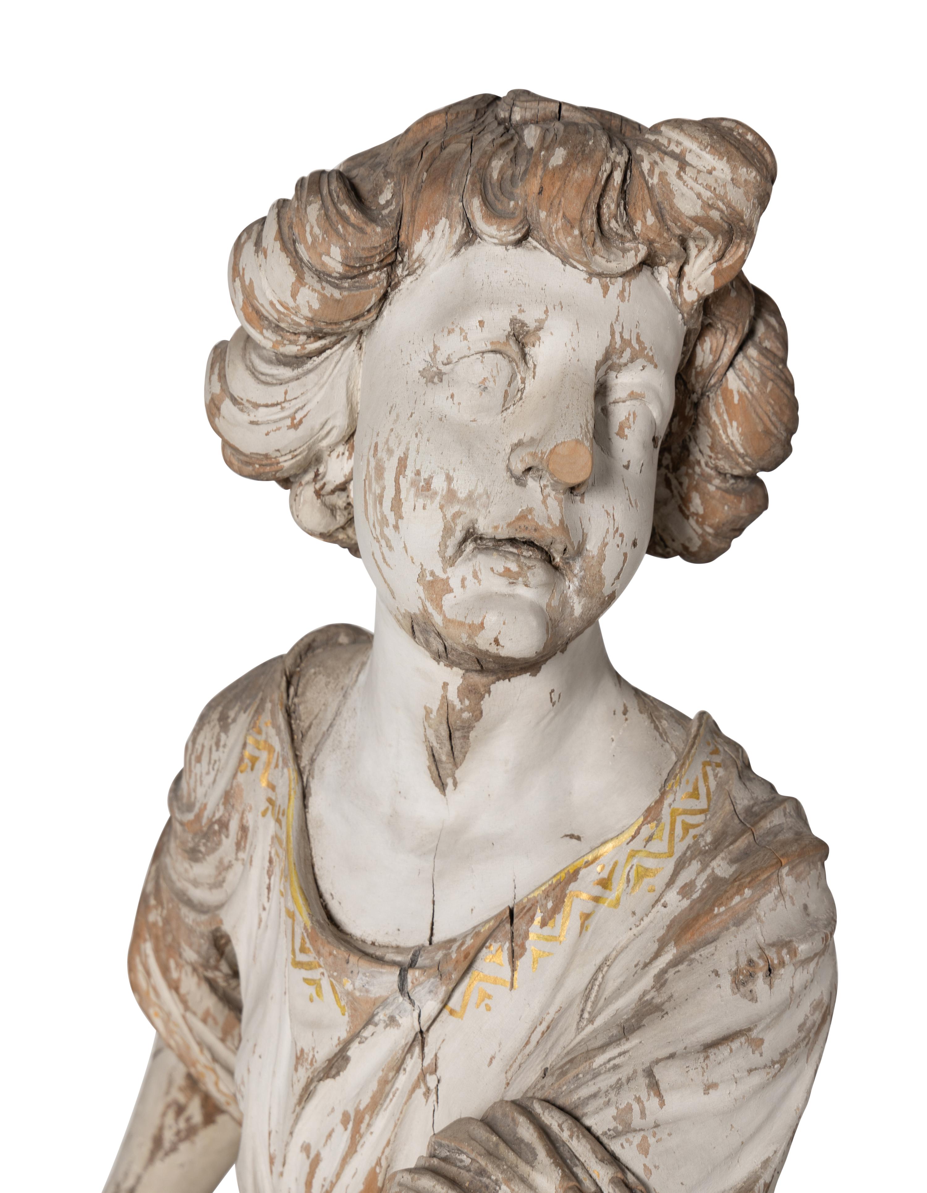 A Set of Three Carved, Painted and Parcel Gilt Wood Figures