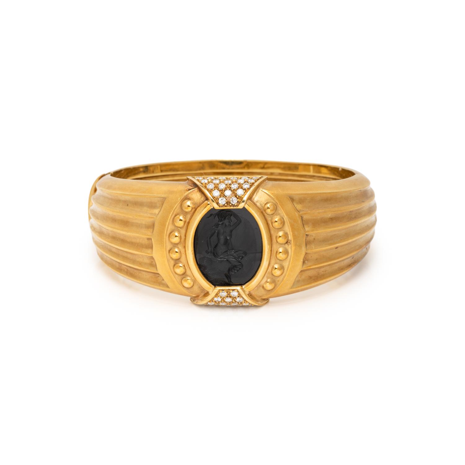 TINELLI, YELLOW GOLD, ONYX, AND DIAMOND 'ARIADNE' BANGLE BRACELET