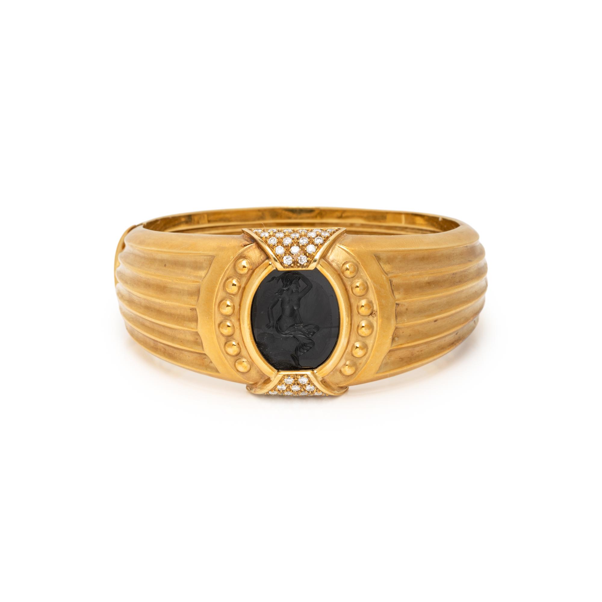 TINELLI, YELLOW GOLD, ONYX, AND DIAMOND 'ARIADNE' BANGLE BRACELET