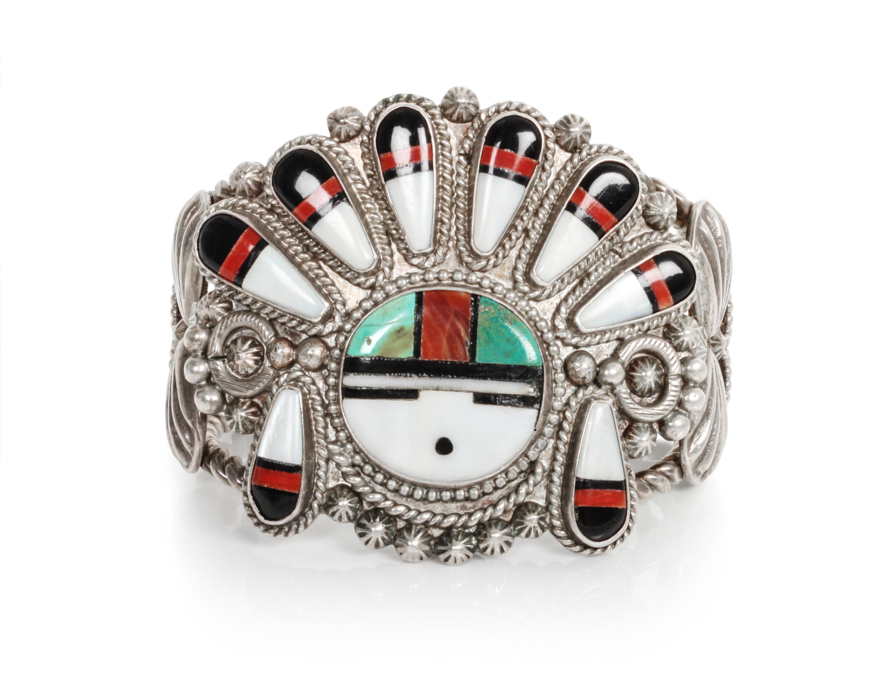 A Zuni Mosaic Sun Face Bracelet Length 5 1/4 x opening 7/8 x width 2 1/4 inches.