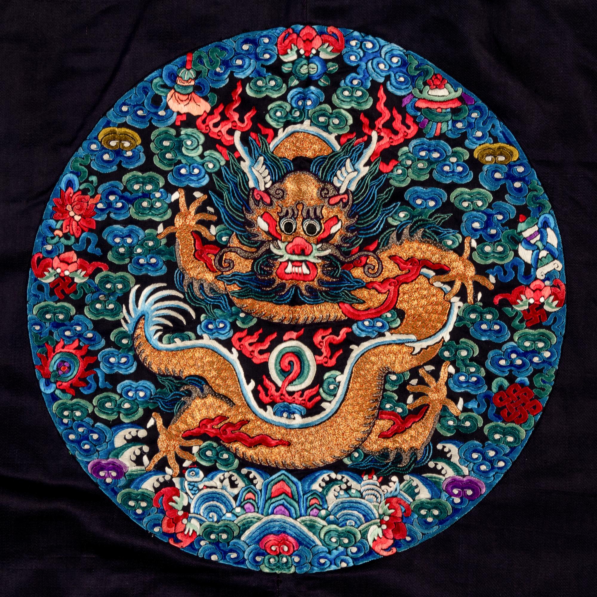 A Chinese Navy Satin Ground Embroidered Silk 'Dragon and Crane' Robe, Qiagua , Late 19th Century 清晚期 石青緞地綉龍紋團鶴紋袷褂